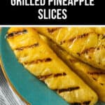 Plate with grilled pineapple slices with visible char marks, placed on a blue dish atop a linen cloth. Text reading 'Brazilian Grilled Pineapple Slices' is at the top, highlighting the delectable grilled pineapple slices just waiting to be enjoyed.
