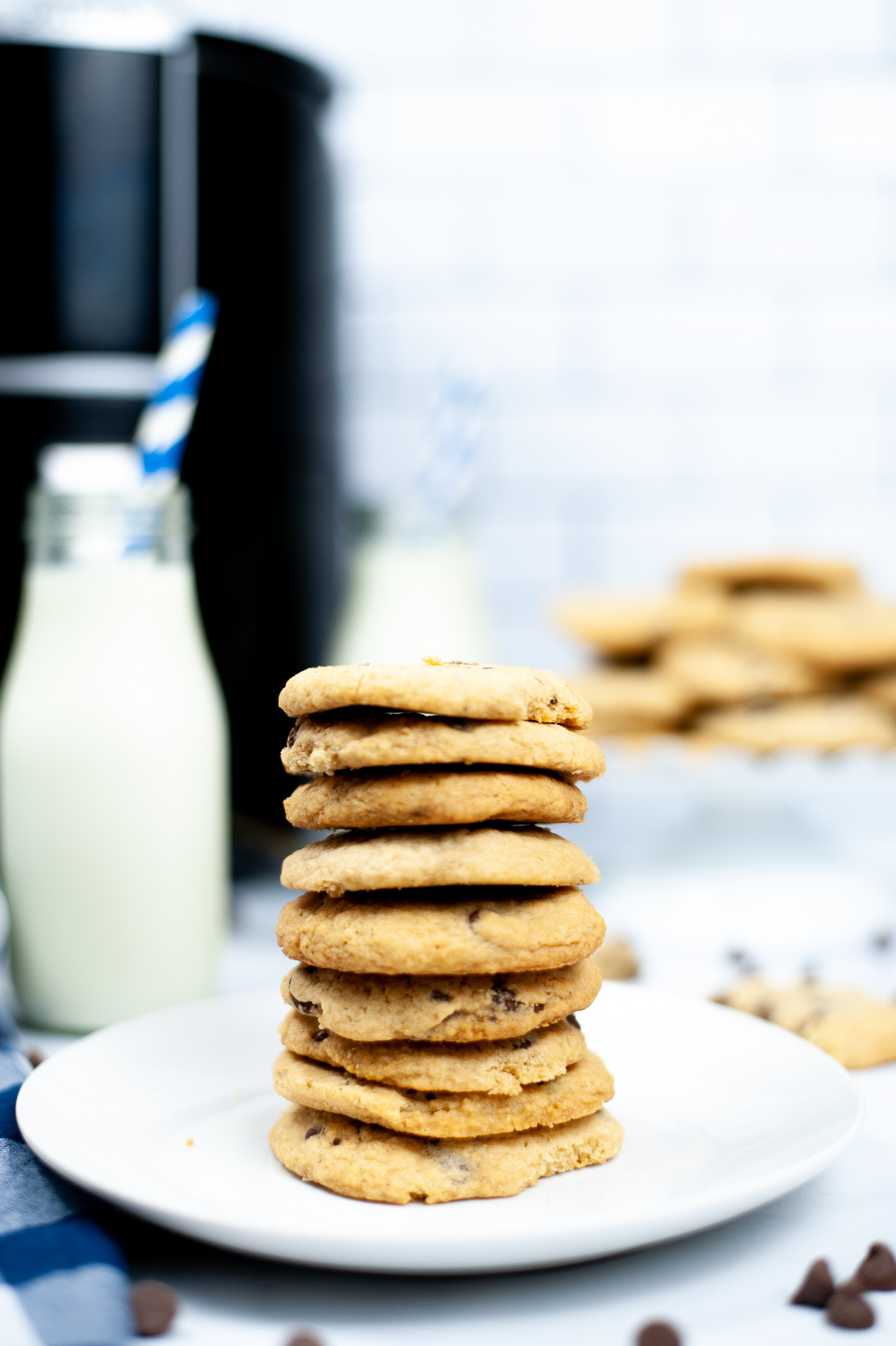 Air Fryer Chocolate Chip Cookies stacked on a round white plate.