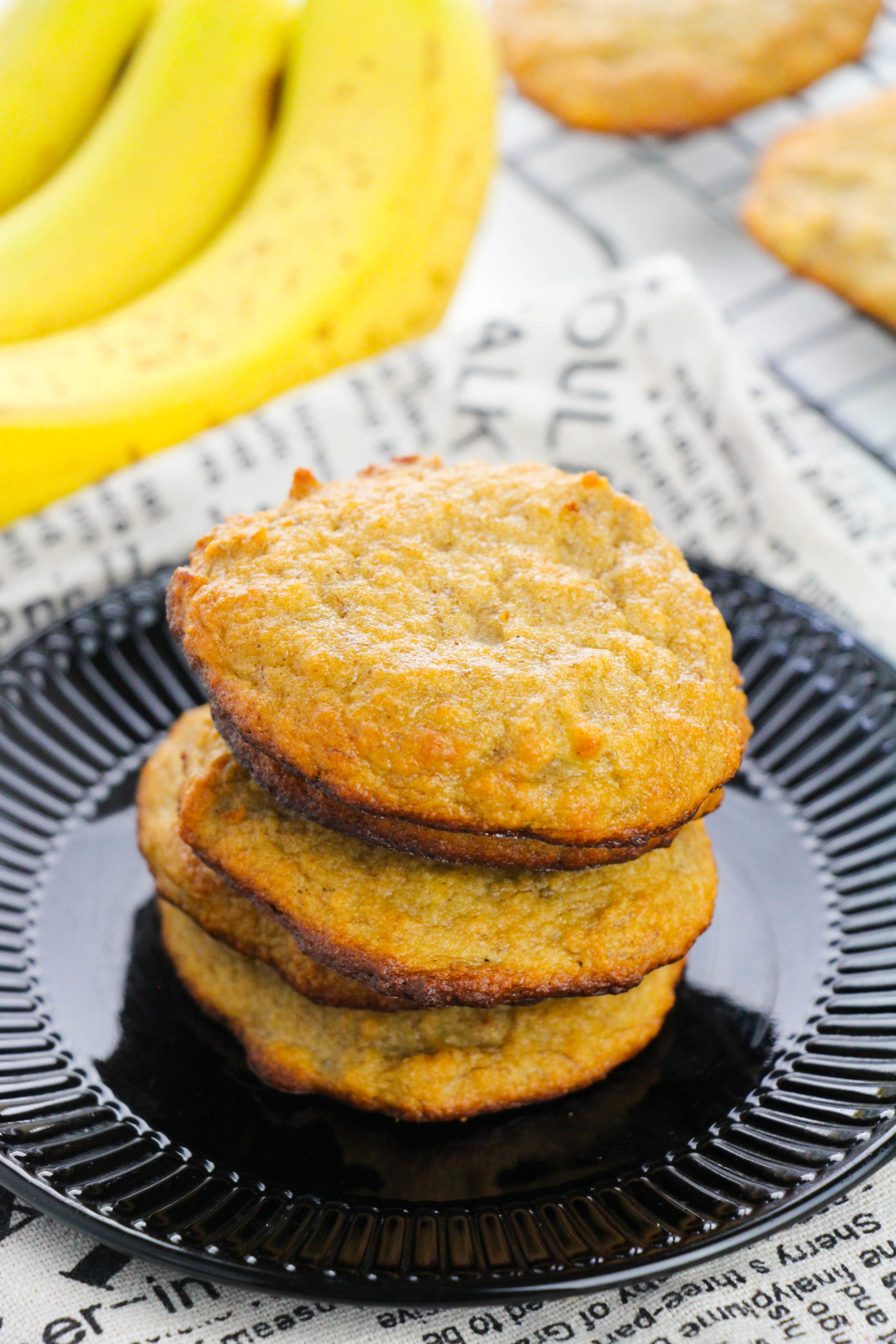 Banana Bread Cookies om a black plate stacked high.