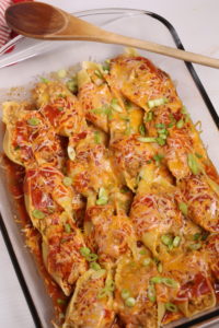 A glass tray filled with Veal Mexican Stuffed Shells.