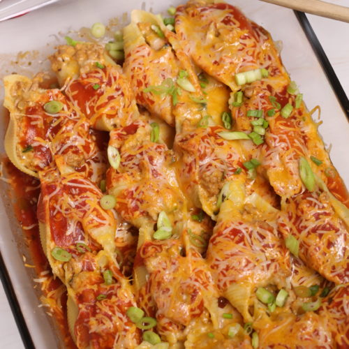 A glass tray filled with Veal Mexican Stuffed Shells.