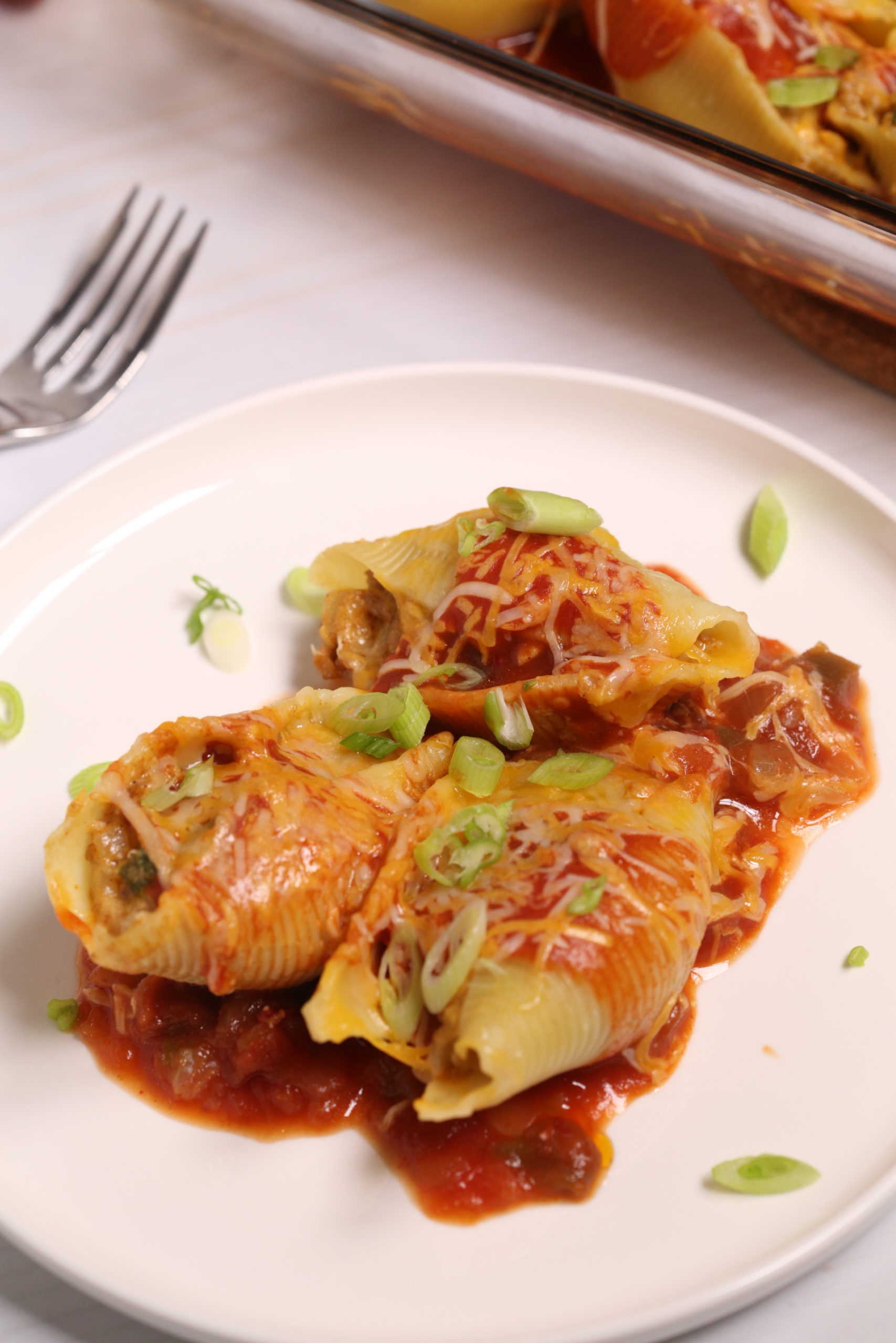 White plate and fork with a serving of 4 veal Mexican Stuffed Shells. 