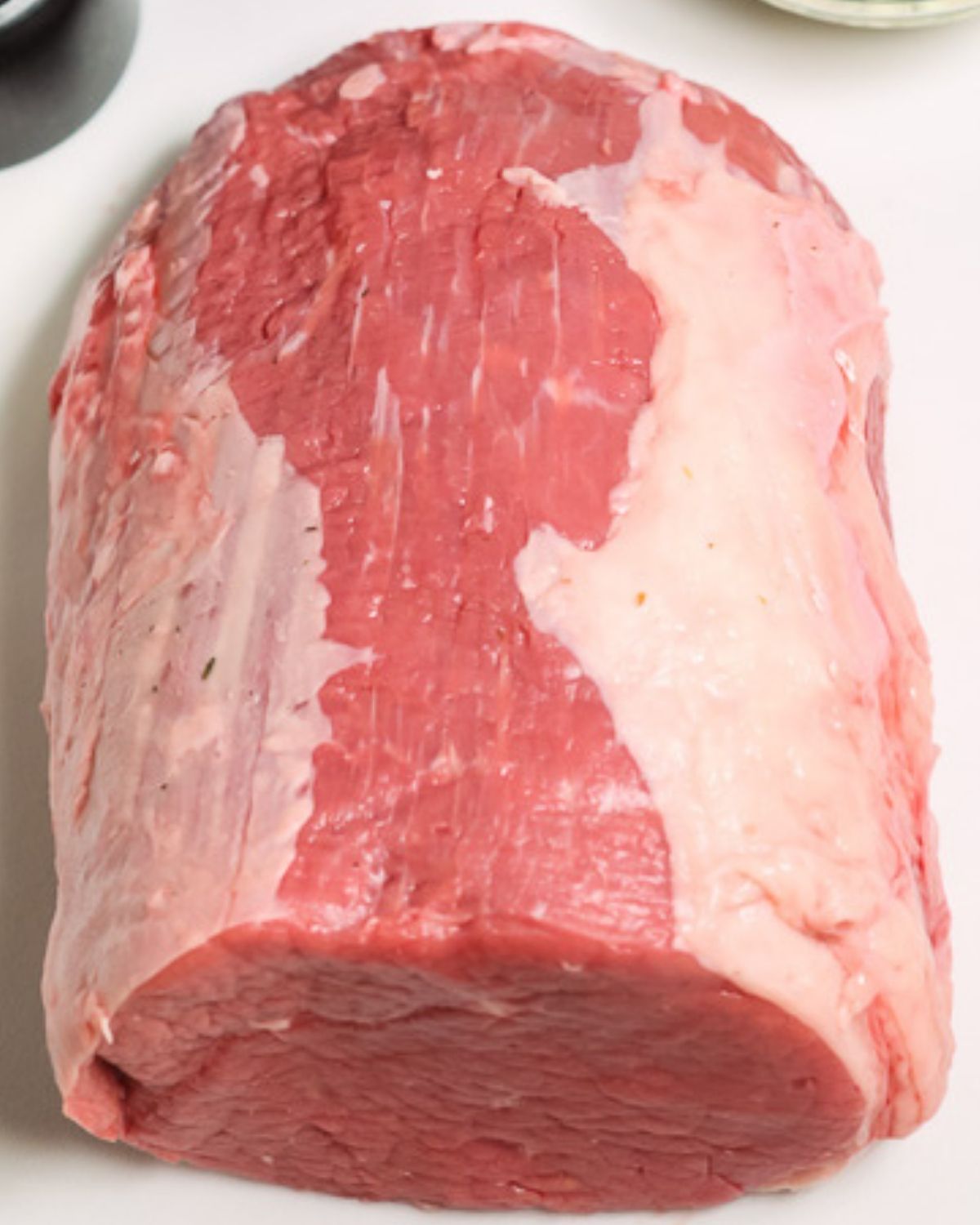 Raw beef roast on a cutting board