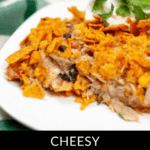 A plate of delightful Dorito Chicken Casserole, topped with a cheesy layer and crushed Doritos, all garnished with fresh cilantro.