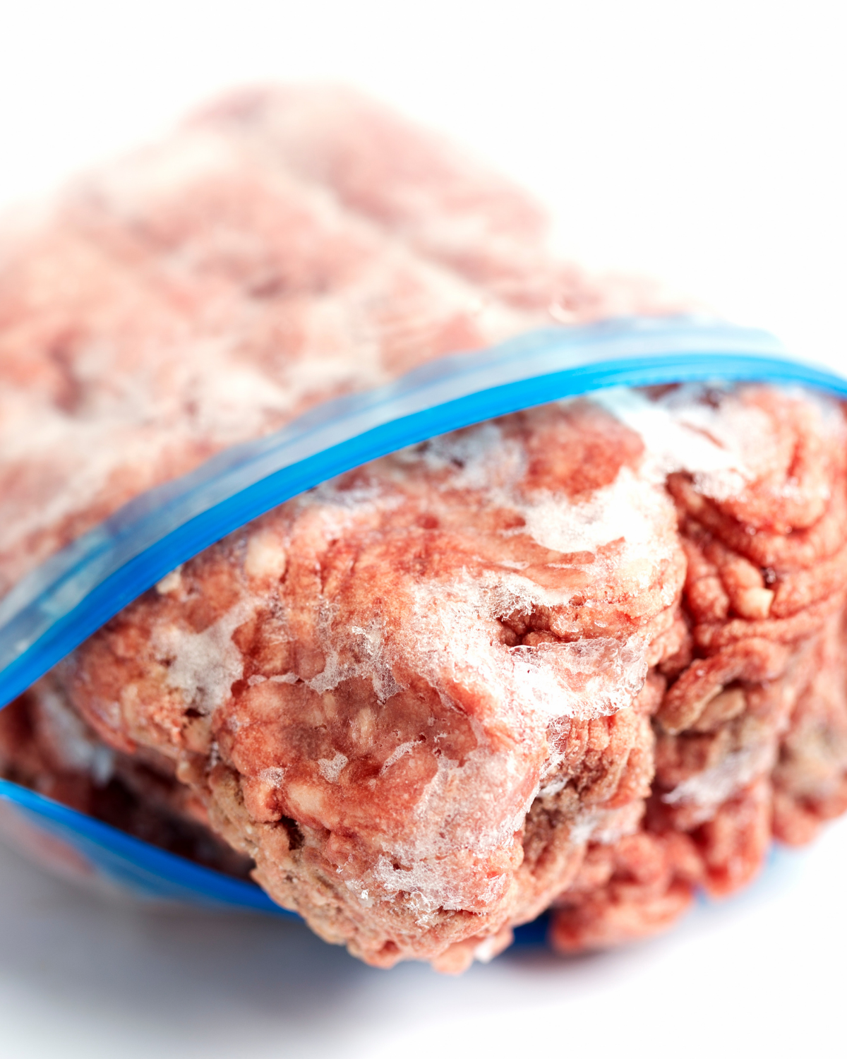 Frozen ground beef in a zipper bag.