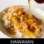 Plate of rice topped with shrimp and pineapple skewers, with sauce being poured over the dish. Text reads "Hawaiian Garlic Shrimp Skewers Delight.