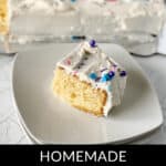 A slice of homemade Vanilla Sheet Cake with white frosting and colorful sprinkles on a white plate, showcasing the rest of the delicious cake in the background. .
