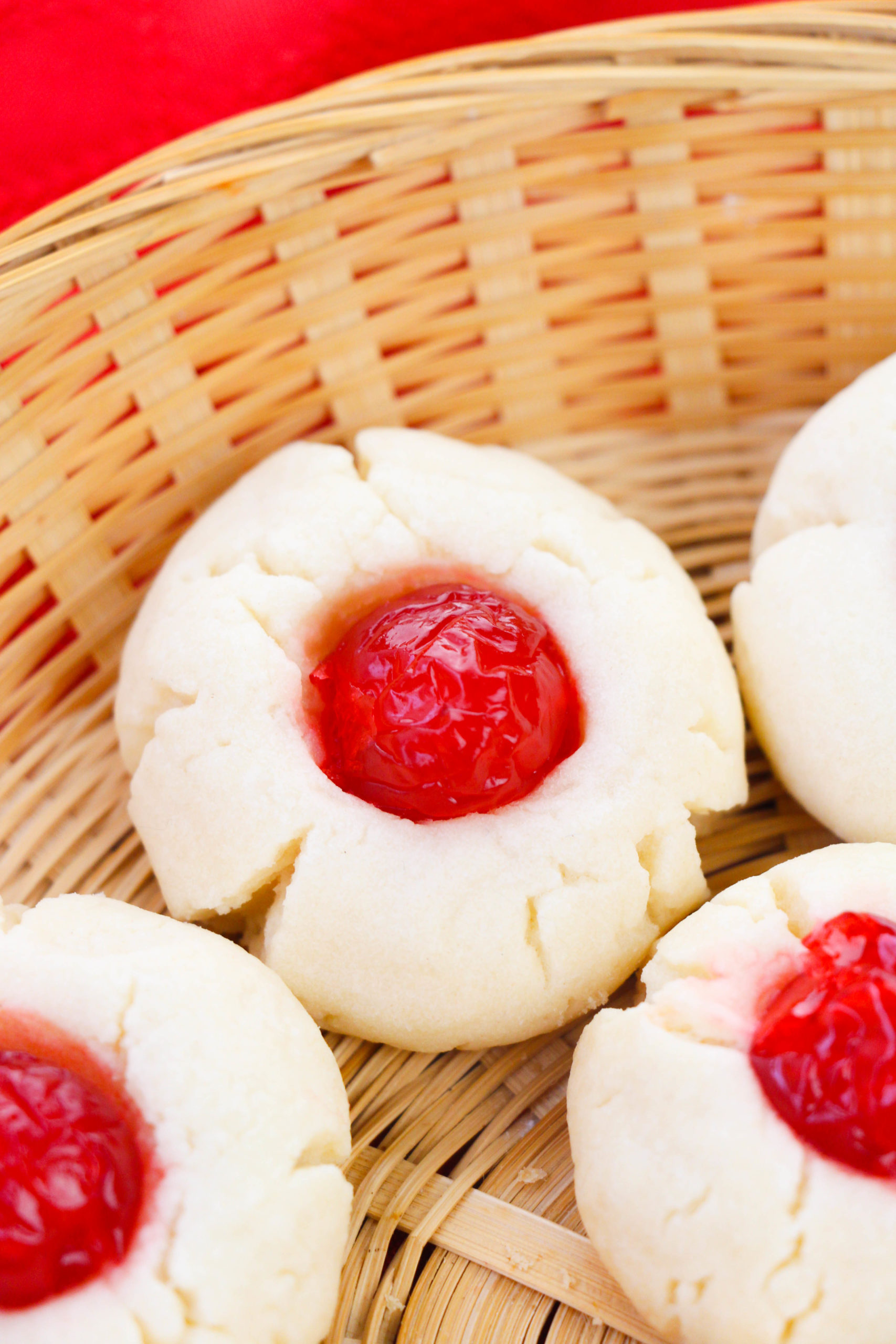 Cherry Shortbread Cookies on a round wicker dish.