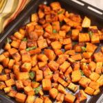 A tray with cubed sweet potatoes on them.