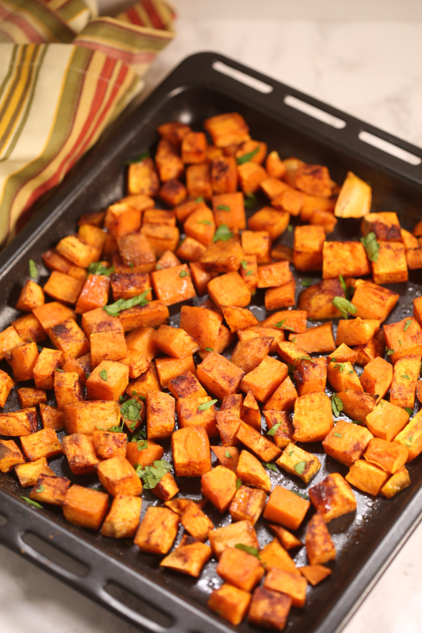 A tray with cubed sweet potatoes on them.