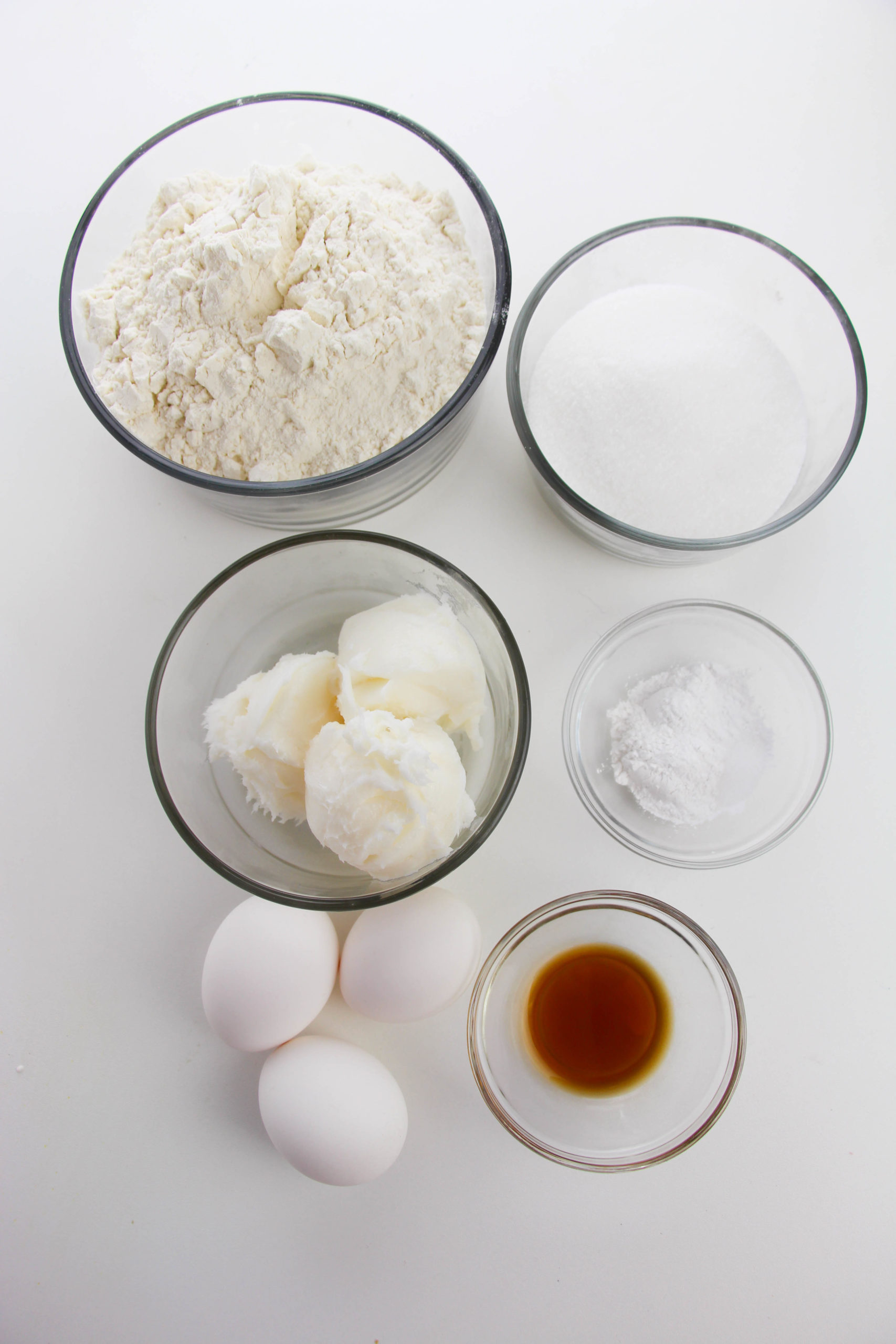 Flour sugar eggs, vanilla and other ingredients for Italian Wedding Cookies. 
