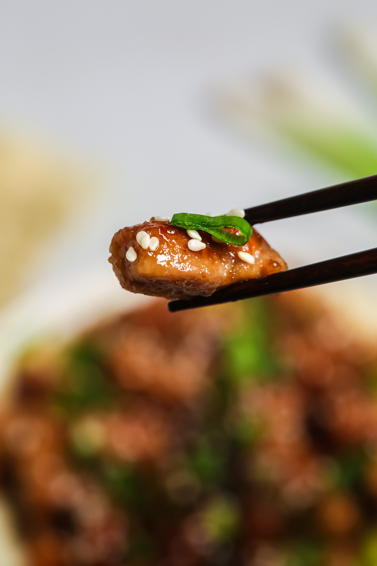 A close up shot of mongolian pork with chopsticks 