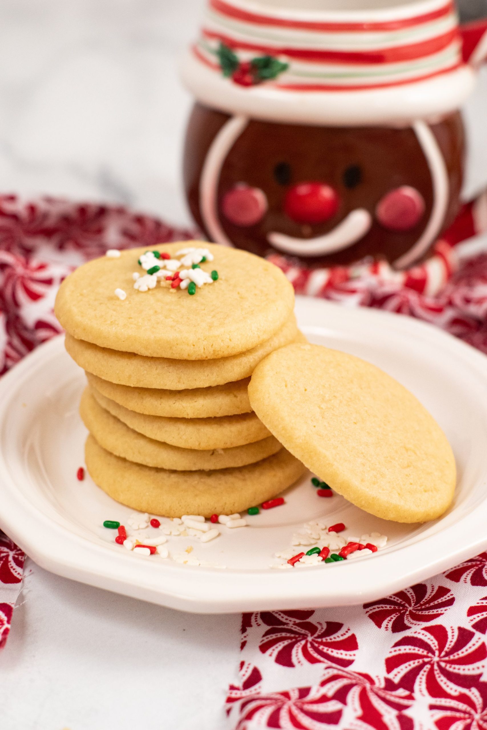 stack of sugar refrigerator cookies with sprinkles on a white plate