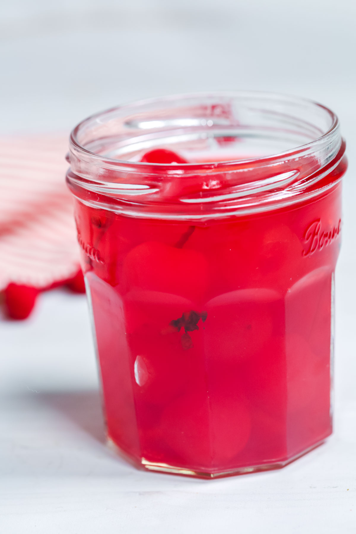 Cherries in moonshine in a jar.
