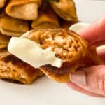 A person is holding a Buffalo Chicken Egg Roll.