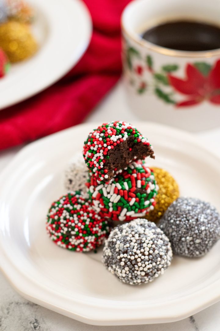 Brownie balls coated in sprinkles and piled on a white plate