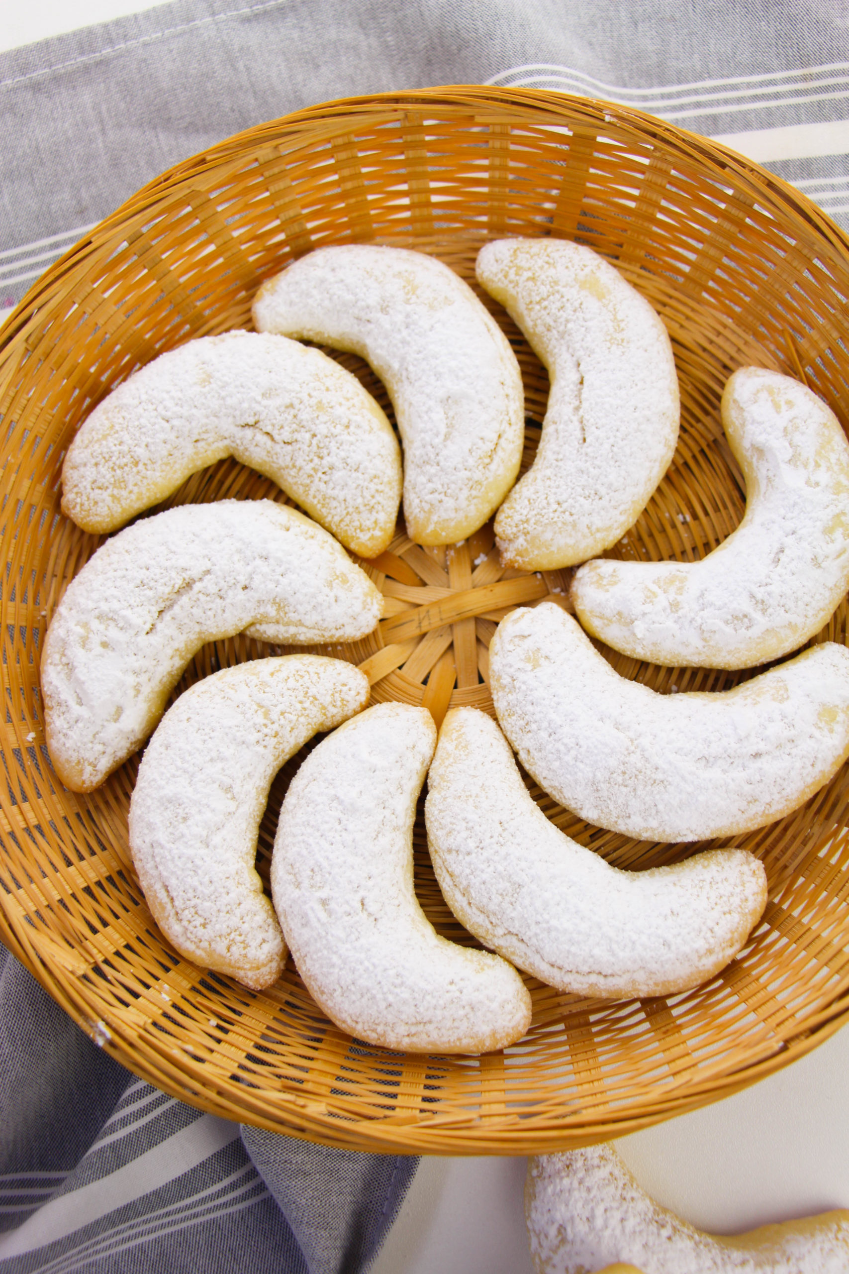 Italian Crescent Cookies arranged on a wicker plate 