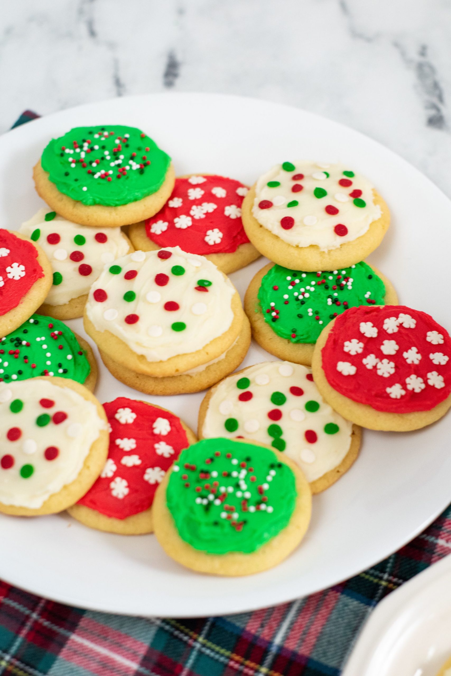 Soft cookies with icing on a white plate