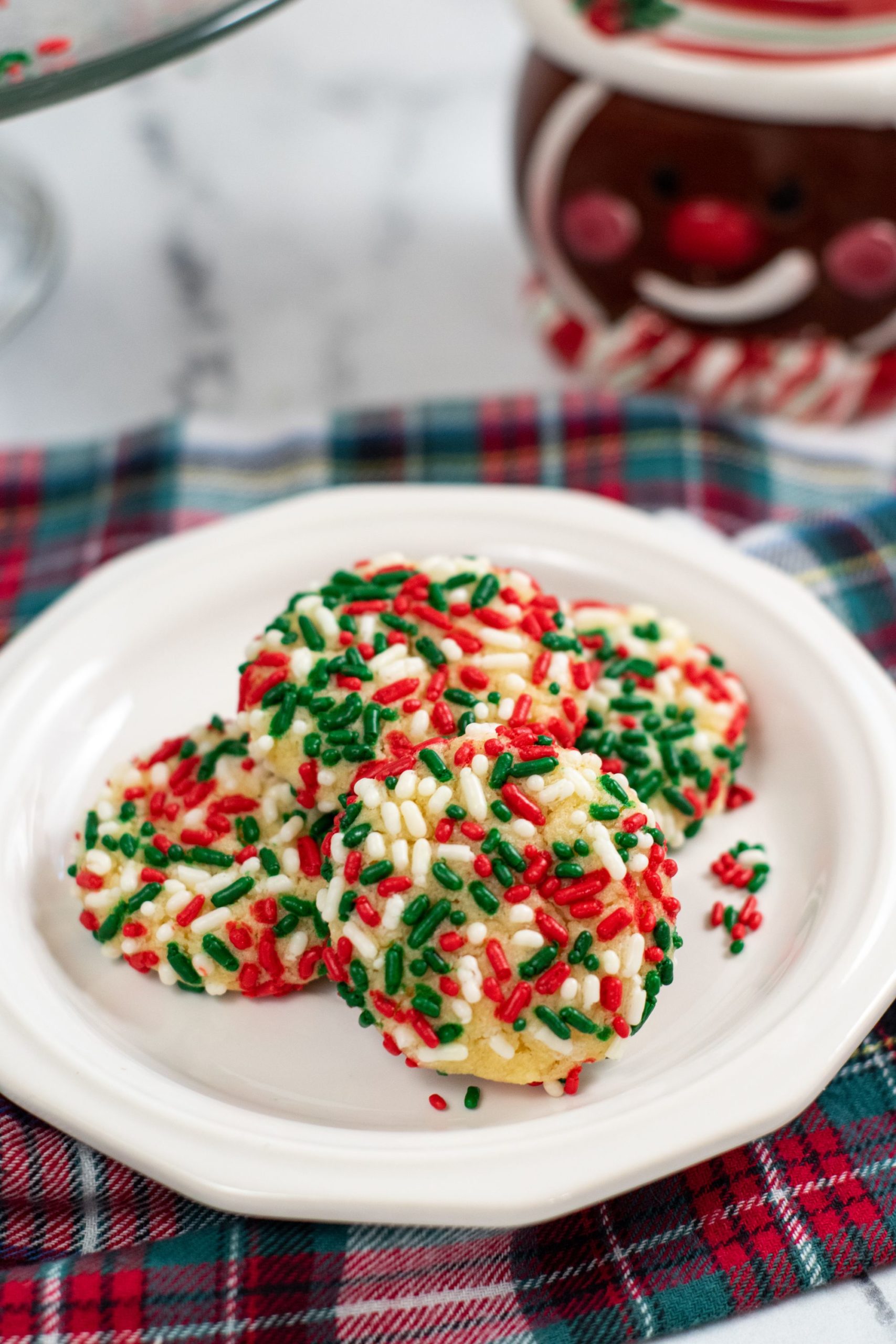 sprinkle cookies on a white plate with a plaid napkin