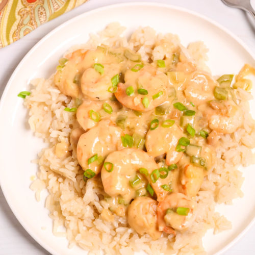 Creamy Garlic Shrimp and Rice on a white plate .