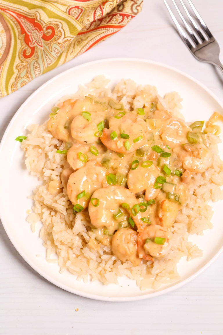 Creamy Garlic Shrimp and Rice on a white plate .
