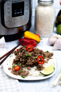 Instant Pot Vietnamese Pork on a white plate with a wedge of lime.