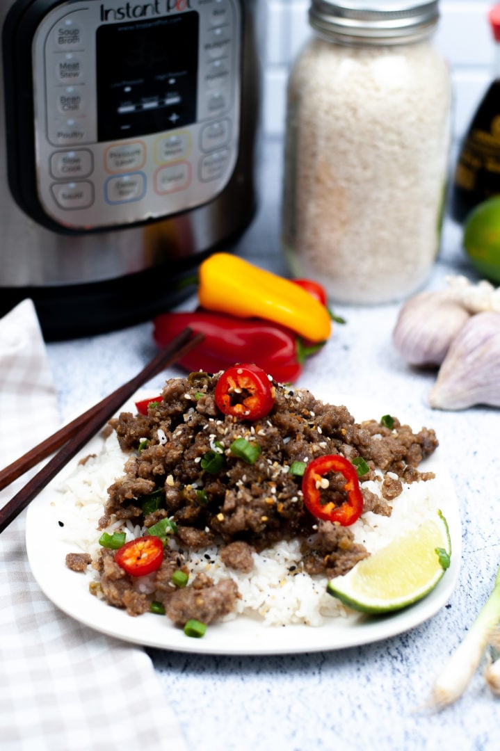 Instant Pot Vietnamese Pork on a white plate with a wedge of lime.