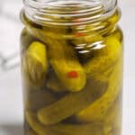 A close up on a jar of moonshine pickles.