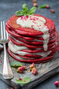 Red Velvet Pancakes stacked high with fresh mint on top.