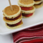 Strawberry Breakfast Bites in a side view with a striped place mat.