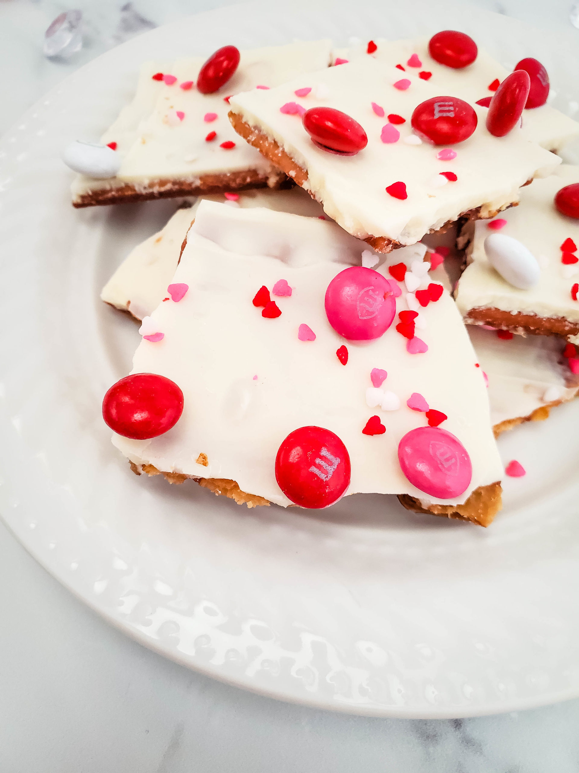 Pieces of the Valentine Chocolate Cracker Bark on a white plate.