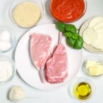 Veal Chops with sauce, cheese, fresh herbs, cheese, etc.