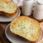 A grey plate with Garlic Bread