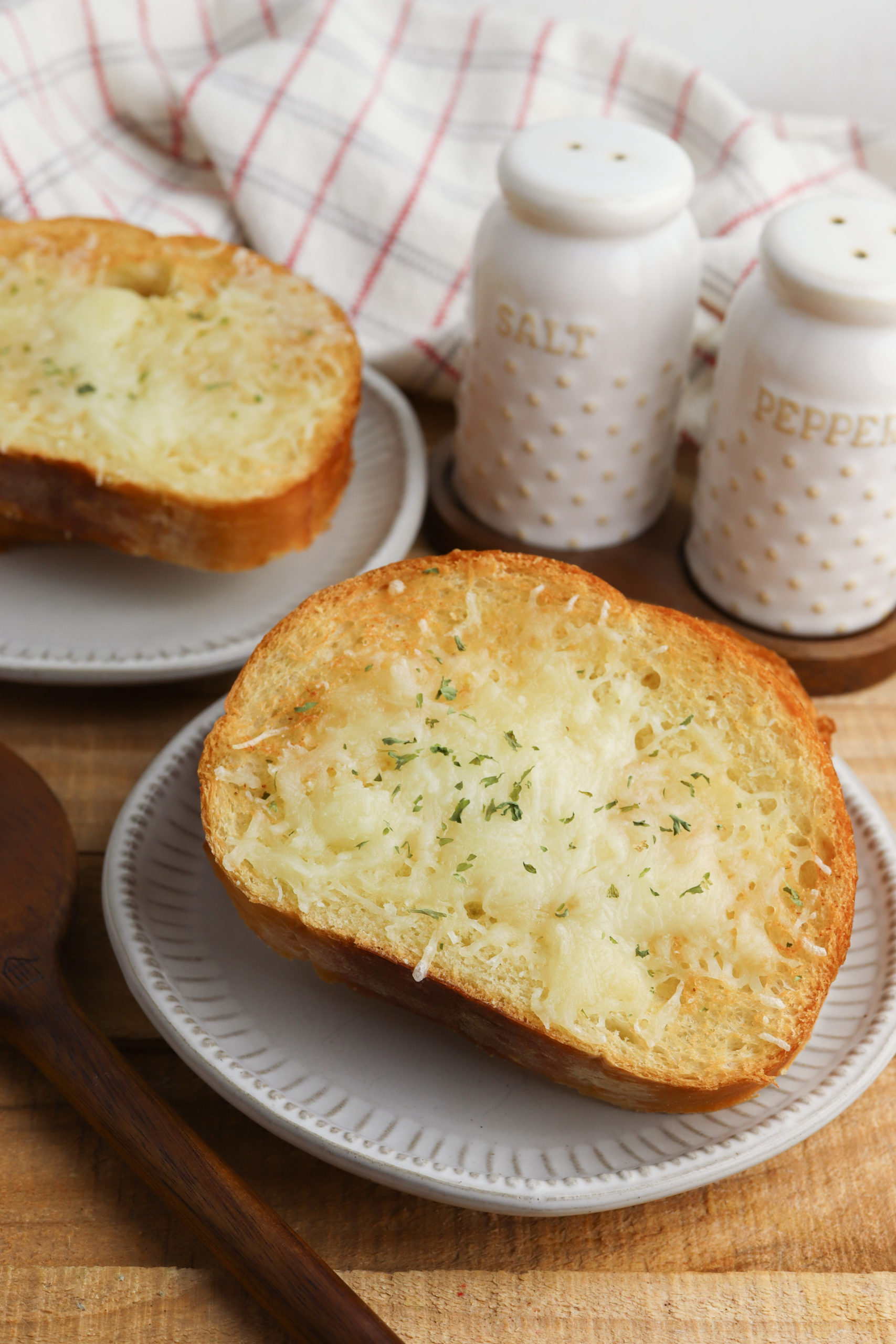 A grey plate with Garlic Bread.