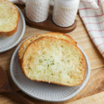Air Fryer Garlic Bread with salt and pepper in the background.