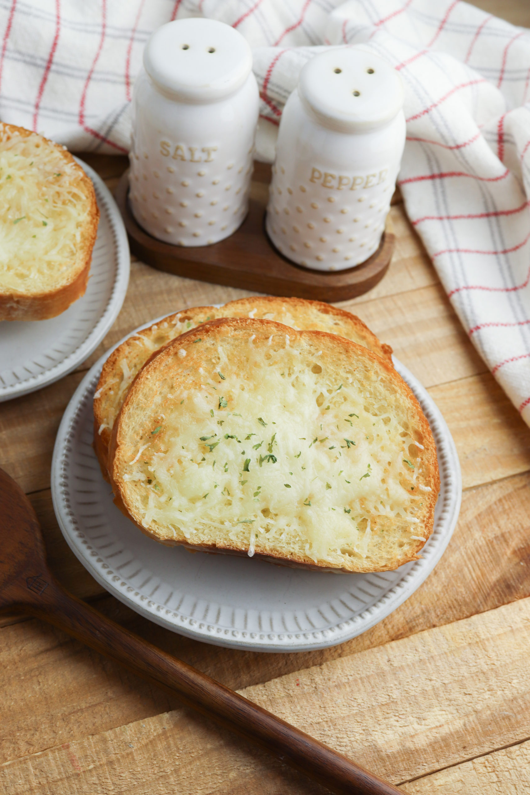  Air Fryer Garlic Bread with salt and pepper in the background.
