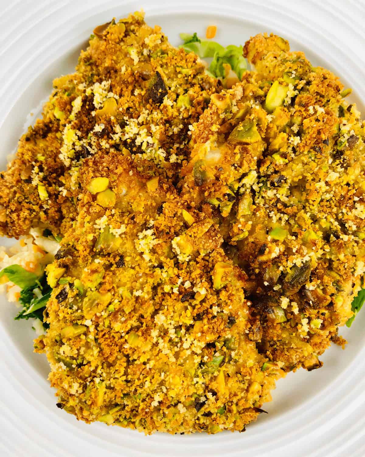 A top shot of the air fryer halibut with pistachio crust.