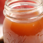 Close up on a jar of apple pie moonshine.