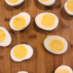 Deviled eggs on a wooden table.