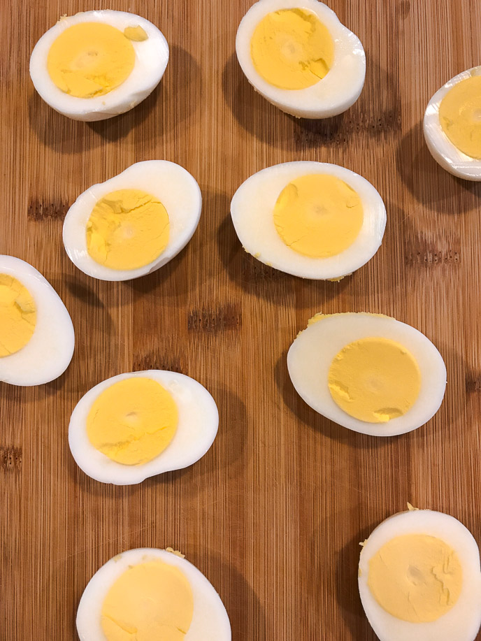 Deviled eggs on a wooden table.