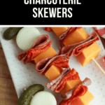 Close-up of charcuterie skewers featuring sliced meats, cheese cubes, baby pickles, and boiled eggs on a white serving tray. A text banner on top reads "Easy & Delicious Charcuterie Skewers." Perfect for entertaining or a quick snack!