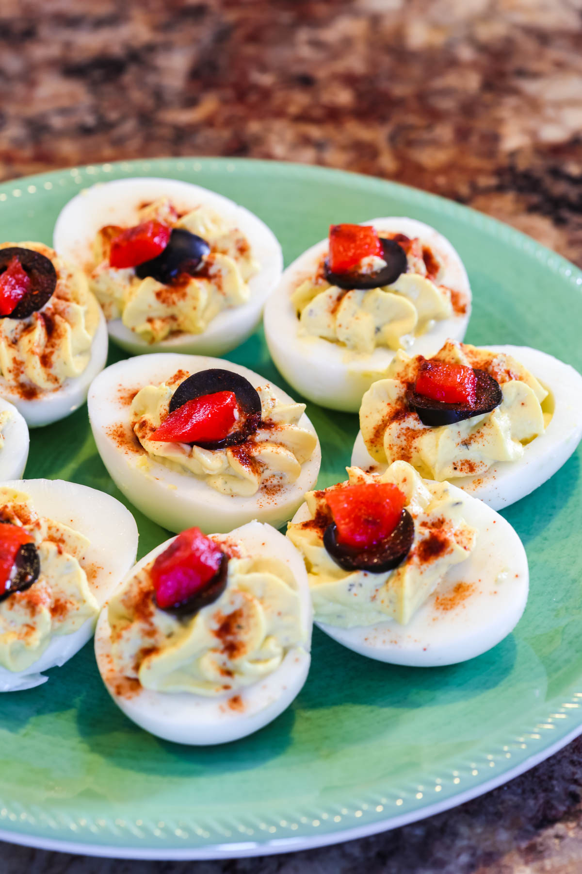 Deviled Eggs without Mayo on a green plate with a blue rim.