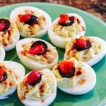 Deviled Eggs without Mayo topped with olives.