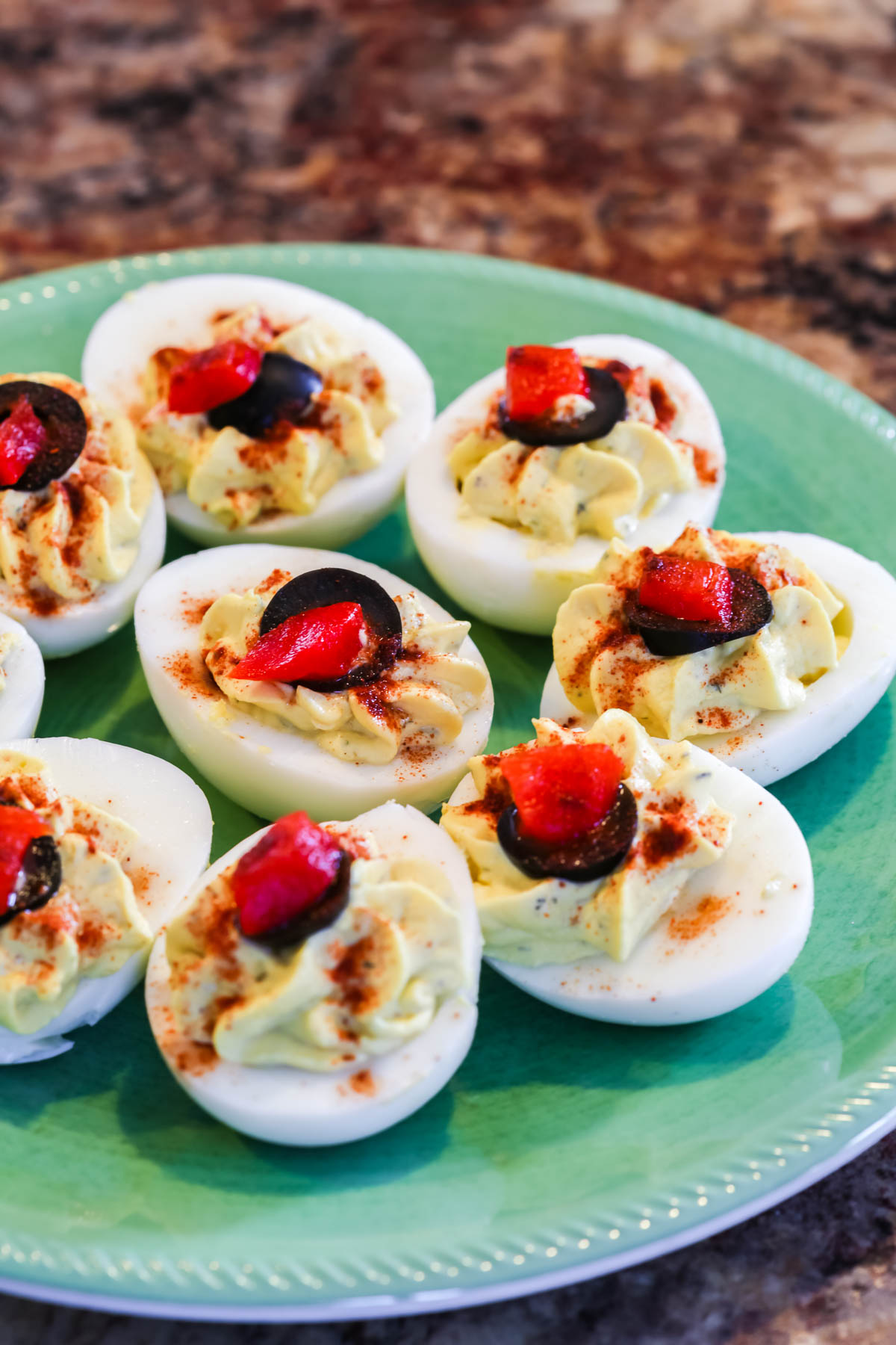 Deviled Eggs without Mayo topped with olives.