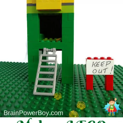 Green legos assembled into a trap with a ladder.