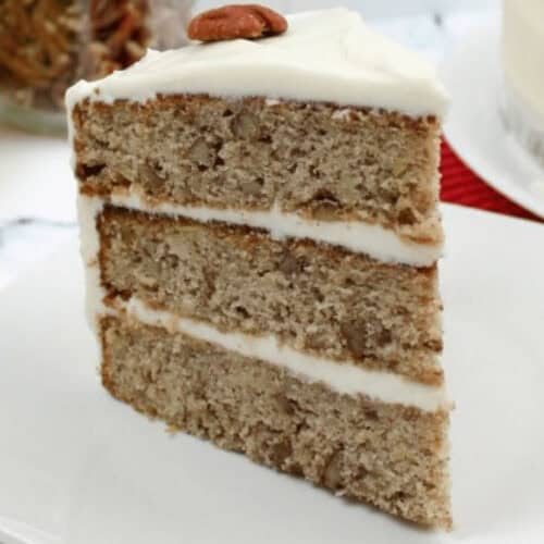 An old fashioned hummingbird cake on a white plate.