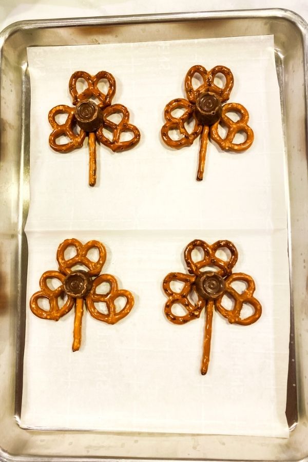 Placing the rolos on the pretzels.