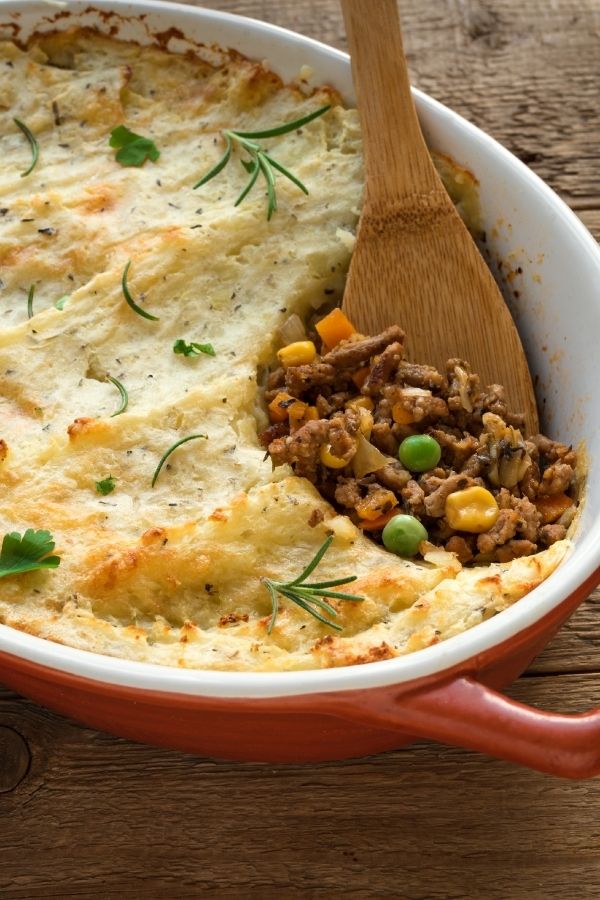 Skillet shepards pie with a wooden spoon in it.