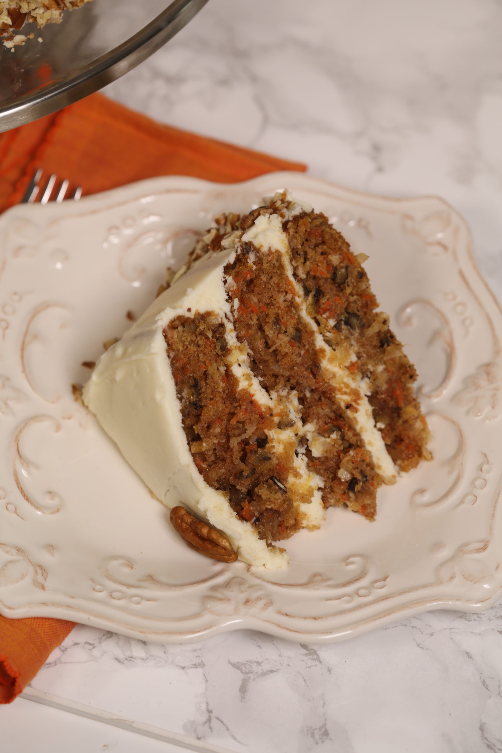 Top picture of the The Ultimate Carrot Cake on a white plate.