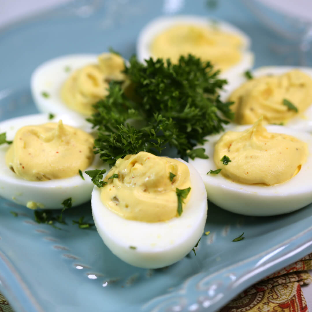 Southern Deviled Eggs with Relish  on a pastel blue platter.